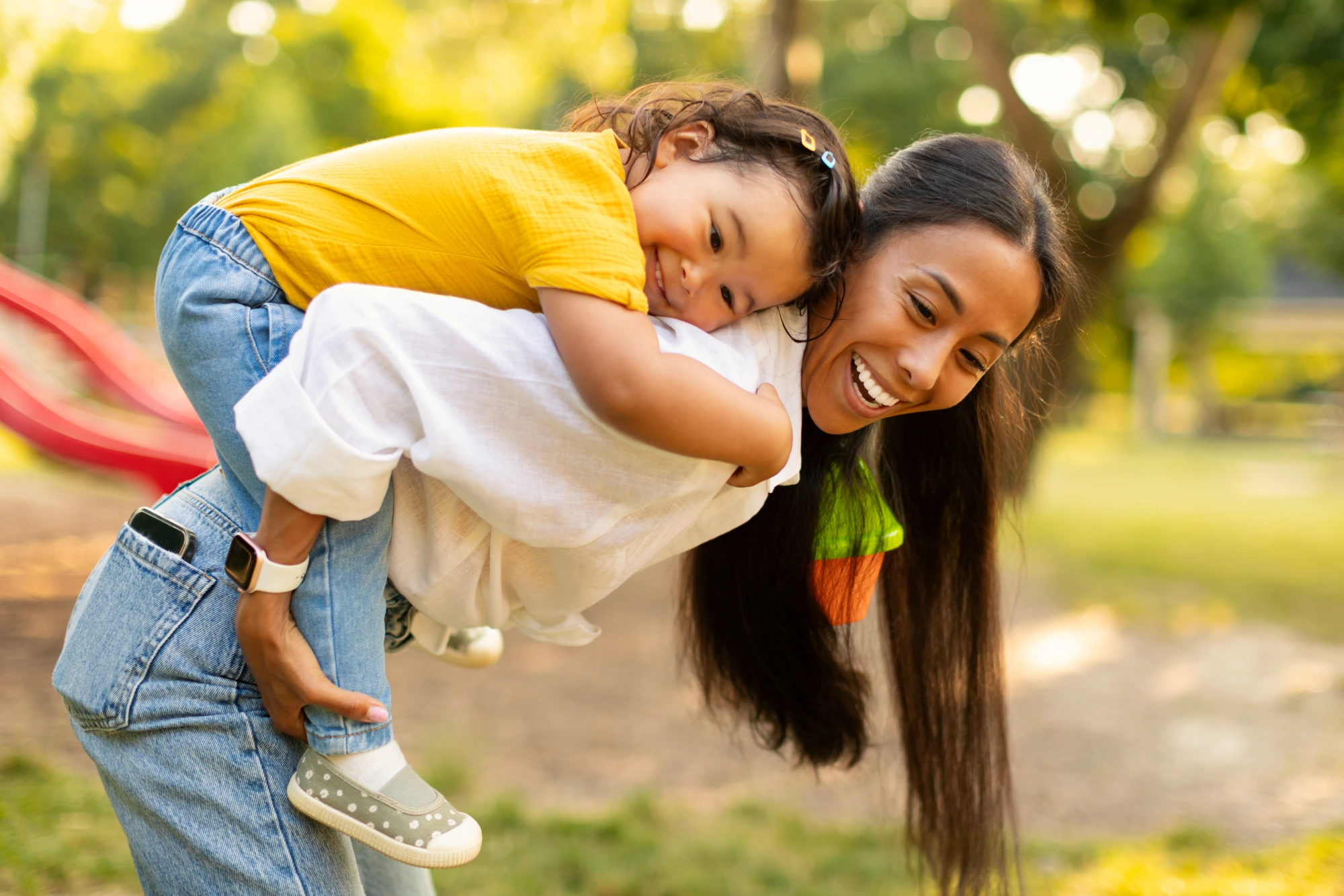 Mother and child laughing together outdoors